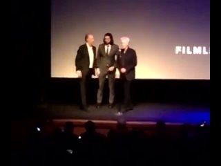 adam driver awkwardly sneaking off the stage