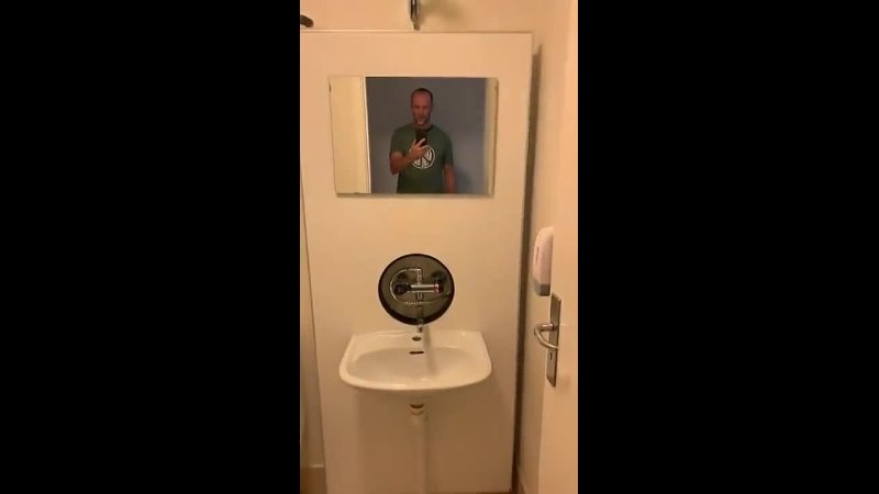American gets a hotel room in Denmark, discovers hidden shower stall.