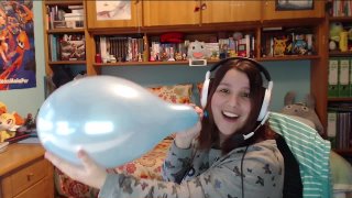Gamer girl burstings a blue balloon