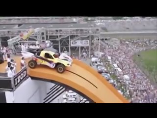 Driver, Tanner Foust, drops down 90 feet of orange track and soars 332 feet in the air.