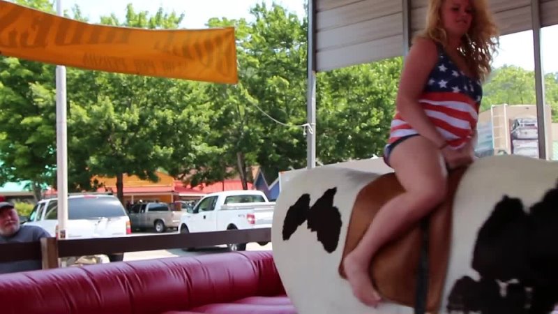 Hot Cowgirl riding a mechanical bull