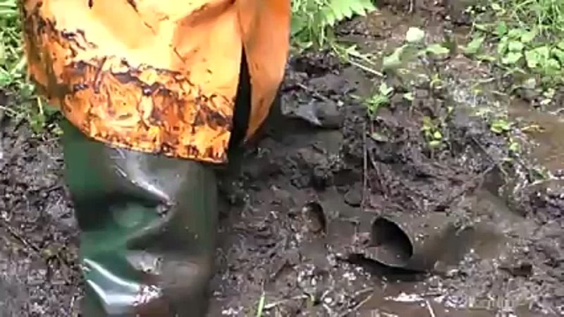 Raincoat girl in deep mud