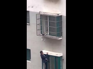 Neighbours rescue boy dangling from 4th-floor window in China #ytshorts (1)
