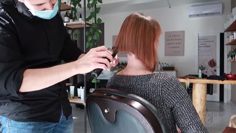 Model Shave Woman with long hair makes an appointment to get her head shaved bald.