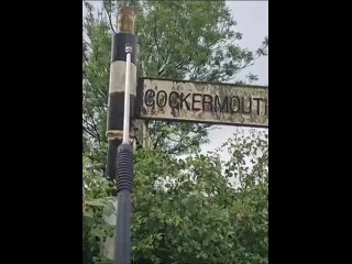 Pressure washing a road sign of an English town