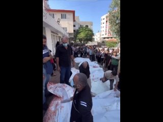 🇵🇸🇮🇱 Palestinians lay bodies of those killed in morning bombing by Israel on street as Al-Shifa Hospital overcrowded due to dete