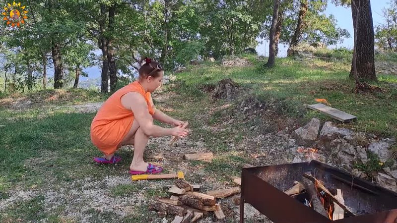 Wood cutting  Mila. cooking on an open fire. Milas Naturist Cooking. Mila 