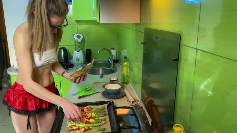 Girl cooking asparagus in short