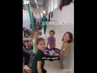 A group of Palestinian girls are playing “martyr game” where they pretend to organize the funeral of the body of a loved one kil