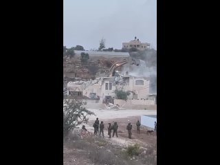 The occupation Zionist army demolishes the house of imprisoned Hamas leader Bagis al-Nakhla near the Jalazoun camp, north of Ram