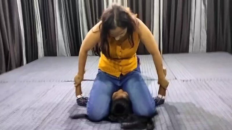 Big Indian girl in jeans sits on little