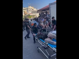 Palestinians deliver wounded and dead, mostly children, to Al-Shifa hospital in Gaza City