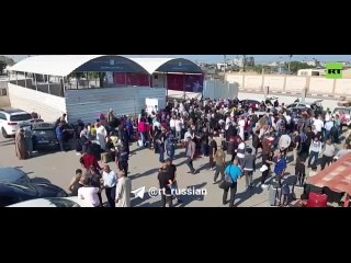 A crowd of Palestinians gathered at the Rafah checkpoint on the border between Egypt and the Gaza Strip.  They wait for the poin