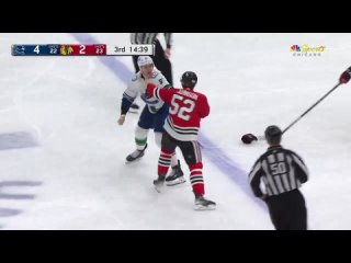 Reese_Johnson_lays_a_big_hit_on_Elias_Pettersson,_and_Nikita_Zadorov