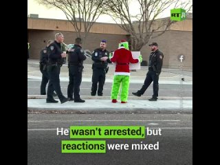 A video with the Grinch standing outside an elementary school with a ’Santa is Fake’ sign, angering parents and scaring kids, ha