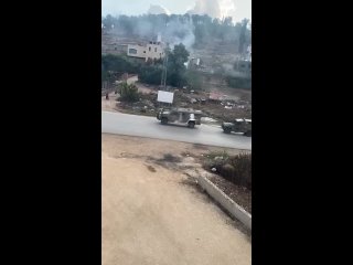 Zombies withdraw the military jeep after it was damaged as a result of being targeted with homemade bombs in the town of Kafarda