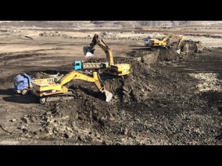 Three Caterpillar 365C Excavators Loading Trucks