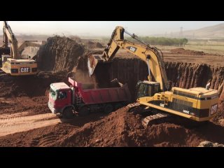 Three Caterpillar 365C Excavators Working By Side