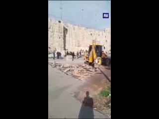 The IDF bulldozing the land adjacent to the wall of occupied Jerusalem