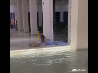 Two Girls Slip and Fall After Walking Through Fountain Barefoot