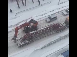 В Новосибирске водитель экскаватора помог грузовику тронуться с места