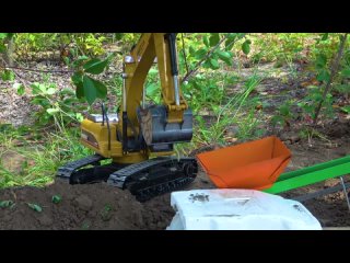 RC Excavator loading  ground Off Road Construction Trucks at Work