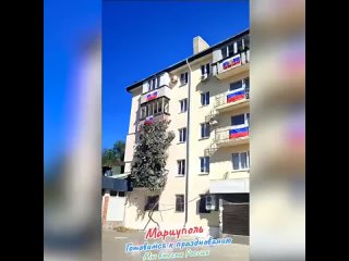 Residents of liberated Mariupol, Russia, proudly display their Russian flags