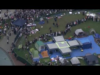 Massachusetts Institute of Technology students break down the fence used by the authorities to enclose their camp