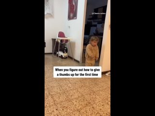 Toddler figures out how to give a thumbs up