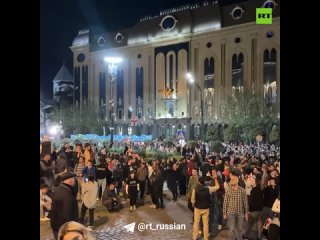 Georgian special forces push protesters away from the parliament building in Tbilisi