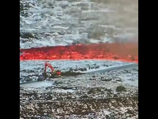 Icelandic worker trying to stop a tide of lava