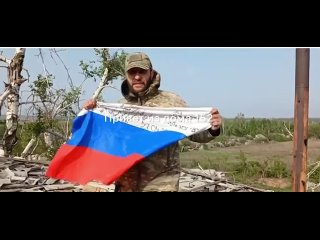 The Russian flag flies over captured Kislovka