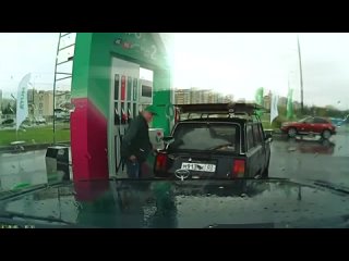 Petrol station worker breakdances on car roof