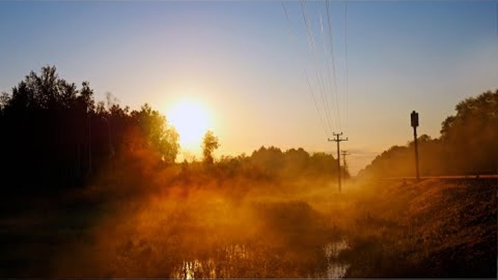 A beautiful sunrise at a distant railway station. Spring sounds of n ...