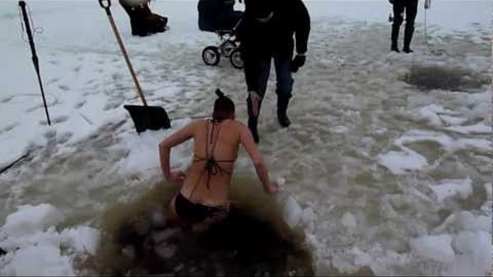 brave girl winter swimming under ice in Estonia