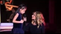 Lara Fabian signs with a little girl