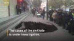 Woman disappears into sidewalk sinkhole, rescued by local co...