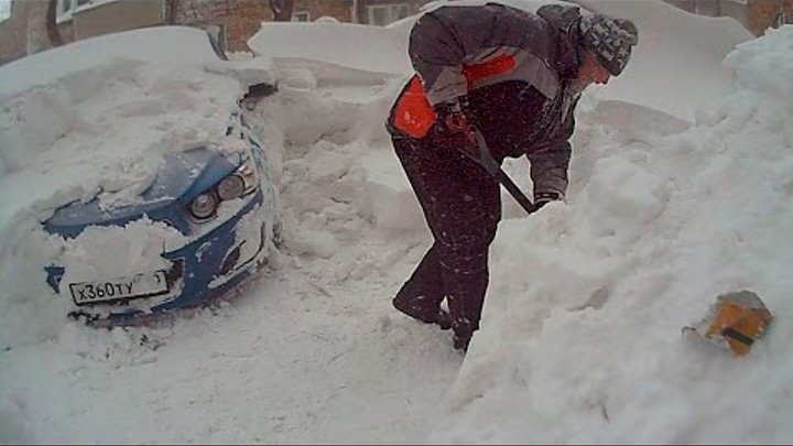 Откопала или откапала. Откапывает машину. Откапывает машину из снега. Мужик откапывает машину. Откапывание машины из под снега.