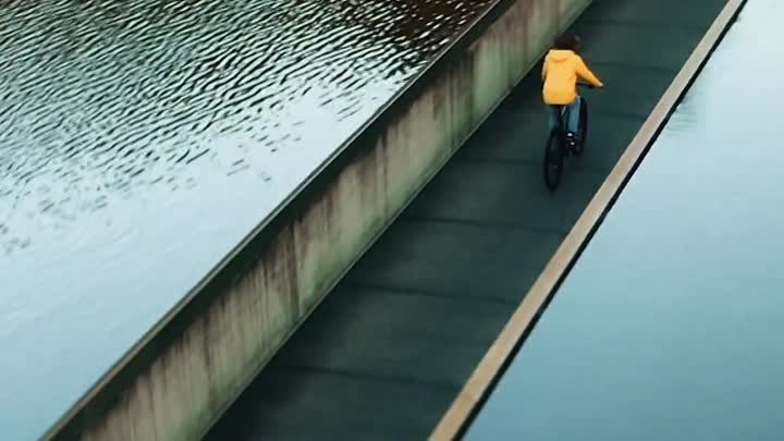 Cycling_through_the_water_in_Belgium_Cant_wish_for_a_more_peacef.mp4