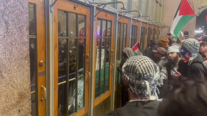 Grand Central Station New York  Pro-Palestinian protesters trying to breach the doors to reach police officers sheltering inside