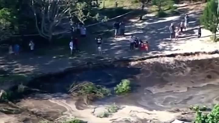 Aerial vision shows extent of the sinkhole on QLD beach