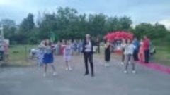 директор сельской школы танцует со своими ученицами