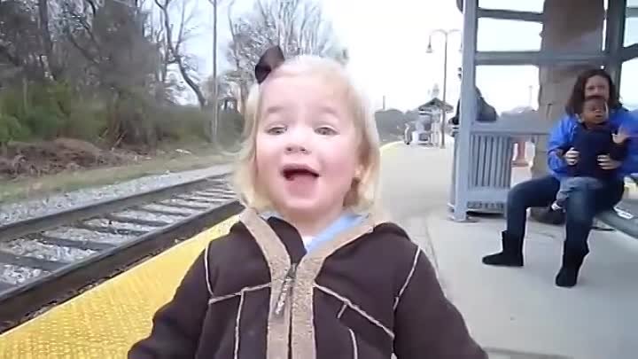 A little girl sees a train for the first time
